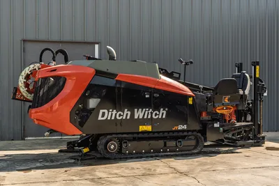 Profile view of 2020 Ditch Witch JT24 HDD drill with tracks, pipe loader, operator station, and clean engine compartment.