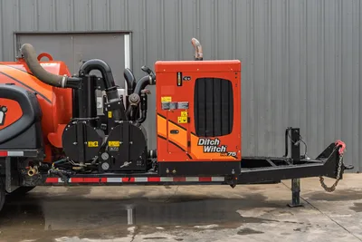 2023 Ditch Witch HX75 mud recycler, side view showing engine enclosure, pump assembly, hoses, gauges, trailer frame, and tow hitch