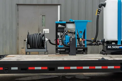 2026 Behnke CBCT2324E-BT-R trailer deck with Straightline SL500 mud mixing unit, bentonite hopper, hose reel, and plumbing connections