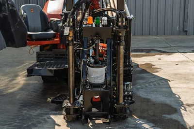 Rear view of 2020 Ditch Witch JT24 HDD drill showing operator station, hydraulic stabilizers, and drill pipe rack.