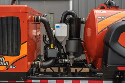 2023 Ditch Witch HX50 mud mixer pump assembly, close-up of centrifugal pump, plumbing, coolant reservoir, and 800-gal tank