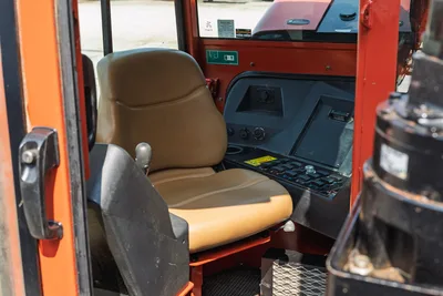 2017 Ditch Witch JT30 cab interior showing operator seat, control panel with switches, display, and diamond-plate floor mat