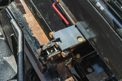 2022 Vermeer D23x30 S3 drill frame close-up showing carriage chain link, thrust block, rack gear, and red allen wrench