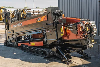 2023 Ditch Witch JT20 drill viewed from the rear, showing steel tracks, engine compartment, and hydraulic pipe loading system.