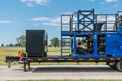2023 American Augers M300DH mud recycler on trailer, side view; blue frame, tank, pump manifold, black engine enclosure, access ladder