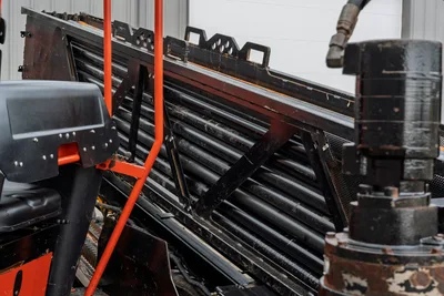 2021 Ditch Witch JT40 drill pipe rack loaded with 3" HDD pipe, operator display mount and vise assembly visible