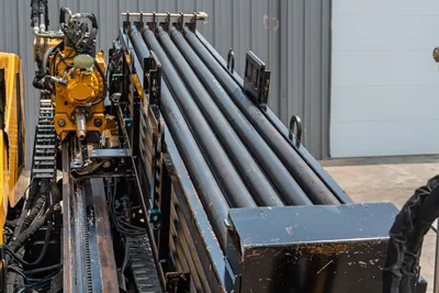2014 Vermeer 24x40 Series II drill pipe rack, carriage assembly, hydraulic motor, and rack-and-pinion drive system closeup.