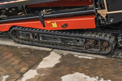 2018 Ditch Witch JT20 horizontal directional drill side view showing rubber track undercarriage and orange engine cowling.