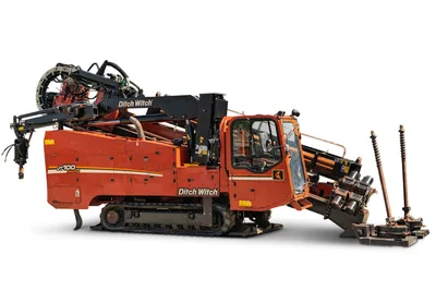 2014 Ditch Witch JT100 Mach 1 HDD rig, side view, rubber tracks, enclosed cab, pipe loader, drill stem, anchor system visible