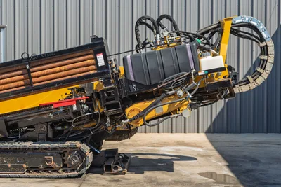 2009 Vermeer D36x50 Series II HDD drill side profile; view of rubber tracks, pipe rack, fluid tank, and hydraulic lines.