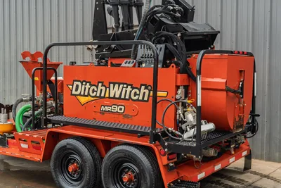 2015 Ditch Witch MR90 mud recycler, rear 3/4 view on tandem trailer, mixing tank, hydraulic lines, green suction hose visible