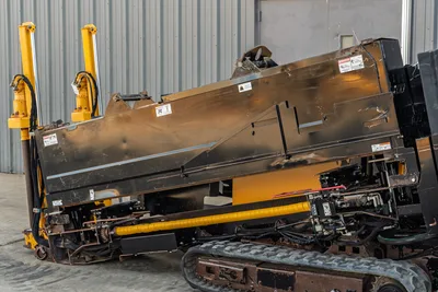 2016 Vermeer D23x30 S3 HDD drill side profile showing drill frame, hydraulic cylinders, rubber tracks, and worn steel enclosure panels