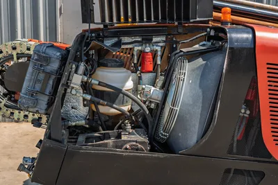 2022 Ditch Witch JT20 open engine compartment showing hydraulic lines, coolant reservoir, oil filter, and cooling fan