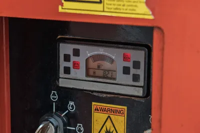 2015 Ditch Witch MR90 mud recycler control panel showing 821 engine hours, fuel gauge at half, warning decals visible