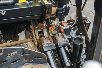 2015 Ditch Witch JT20 carriage assembly overhead view showing rack gear, vise jaws, hydraulic cylinders, and drill pipe holders