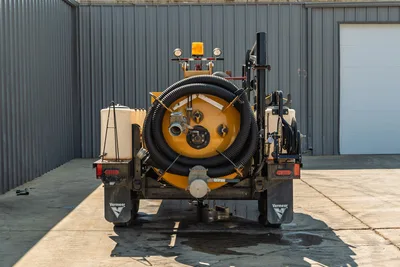 Rear view of 2024 Vermeer LP573SGT vacuum excavator showing spoil tank, suction hose, water tanks, and reel assembly.