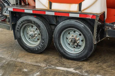 2021 Ditch Witch HX50 mud mixer trailer dual-axle tandem wheels, Advanta tires, white poly tank, orange mixing drum visible above frame