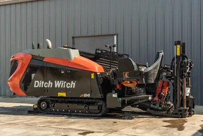 2020 Ditch Witch JT24 directional drill, side profile view, showing tracks, operator station, and drill pipe rack.