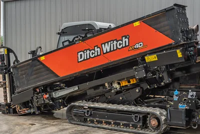 Side view of 2021 Ditch Witch AT40 HDD drill showing tilted rack, rubber tracks, operator station, and hydraulic lines.