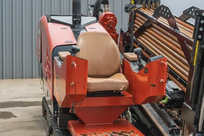 2021 Ditch Witch JT25 operator station showing drill pipe rack, joystick controls, exhaust stack, and tracked undercarriage.