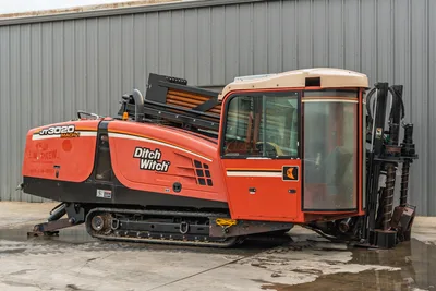 2012 Ditch Witch JT3020 Mach 1 HDD drill, profile view, showing tracks, enclosed cab, pipe box, engine housing, and carriage.