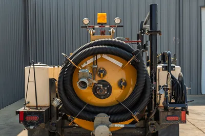 Rear view of 2024 Vermeer LP573SGT vacuum excavator showing spoil tank, storage hose, water tanks, and integrated boom assembly.
