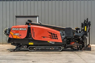 2021 Ditch Witch JT20 HDD drill, full driver-side profile, rubber tracks, pipe rack loaded, drill frame, operator console visible