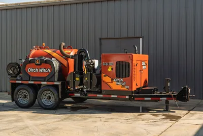 2022 Ditch Witch HX30 mud recycler on tandem-axle trailer, 3/4 view, orange tank, engine enclosure, hose reel, vacuum hose visible