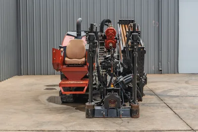 Rear view of 2021 Ditch Witch JT25 HDD rig, showing drill pipe rack, rotation drive, operator seat, and stabilizer legs.