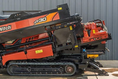 2017 Ditch Witch JT30 HDD drill, side view showing elevated drill frame, spindle/carriage, rubber tracks, and anchor system.