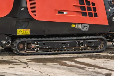 Side view of 2018 Ditch Witch JT20 engine compartment, chassis housing, and rubber tracks in operational condition.