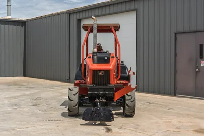 Front view of 2017 Ditch Witch RT80 utility tractor showing engine hood, ROPS, exhaust stack, and tires on concrete lot.