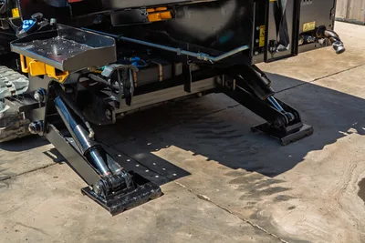 2016 Ditch Witch JT30 All Terrain stabilizers and hydraulic cylinders in clean condition. Low-angle view of track undercarriage.