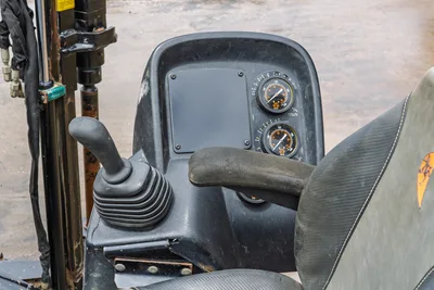 2018 Ditch Witch JT10 operator station, featuring control joystick, dual pressure gauges, and contoured seat assembly.