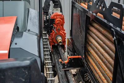 2024 Ditch Witch JT24 red spindle drive head on drill frame with 2.25" pipe rack loaded with 10ft drill rods