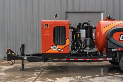 2023 Ditch Witch HX75 mud mixing system on trailer, side view showing engine enclosure, pump assembly, and mixing tank