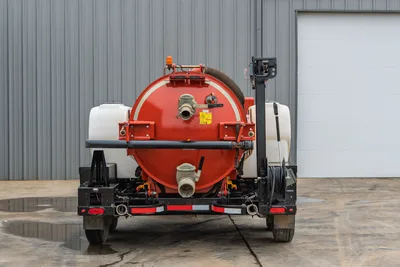 Rear view of 2019 Ditch Witch HX30 vacuum excavator, showing spoil tank, discharge valve, water tanks, and hose assembly.