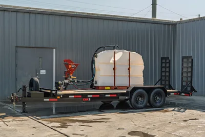 2023 MAXX-D C6X mud mixing trailer, driver-side view, large white poly water tank, Ditch Witch mixer, tandem axle, fold-down ramps