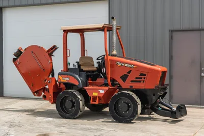 2017 Ditch Witch RT80 utility tractor with rear trencher attachment, side profile, wheeled chassis, and open ROPS station.