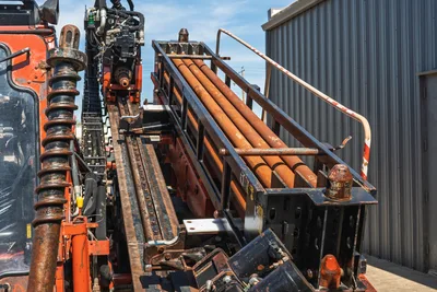2014 Ditch Witch JT100 Mach 1 drill frame, pipe rack loaded with 3.5" HDD drill pipe, rack-and-pinion carriage, used condition