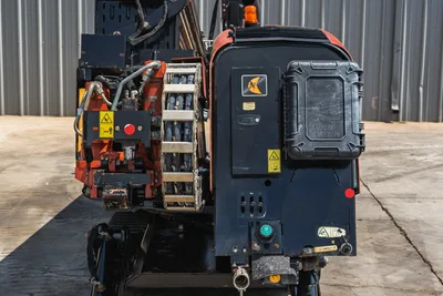 2021 Ditch Witch JT20 rear view showing hydraulic hose tray, fluid lines, engine compartment panel with Ditch Witch branding, and rubber tracks.