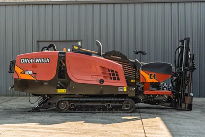 2021 Ditch Witch JT28 HDD drill, full profile view, rubber tracks, loaded drill pipe rack, vise assembly, and anchoring system visible.