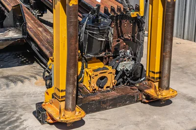 Vermeer D40x55 S3 HDD drill frame close-up showing vise assembly, hydraulic components, drill pipe, and rack rail with wear patina