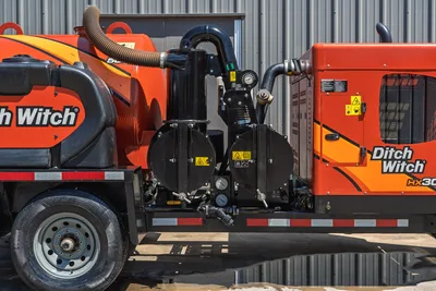 2023 Ditch Witch HX30 mud recycler pump assembly close-up, dual diaphragm pump, gauges, hoses, orange tank, trailer-mounted