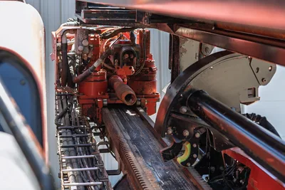 2018 Ditch Witch JT30 All Terrain spindle, carriage assembly, rack-and-pinion drill frame, hydraulic lines, and pipe loader closeup