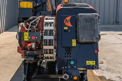 2022 Ditch Witch JT20 rear view showing drill pipe carousel, hydraulic components, fluid tank panel, and Ditch Witch logo decal