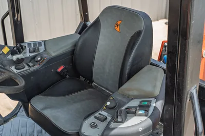2024 Ditch Witch RT125Q operator seat with branded logo, seatbelt, joystick controls, toggle switches, low-hours interior in clean condition.