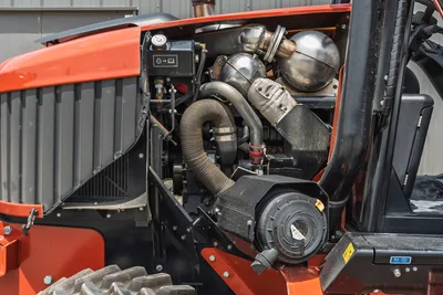 2024 Ditch Witch RT125Q open engine compartment showing diesel engine, turbo, exhaust components, radiator, and air filter