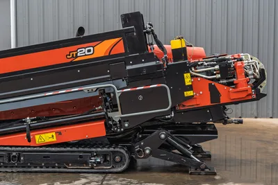 Ditch Witch JT20 HDD rig side view showing drill head, hydraulic manifold, 2.06" drill pipe, and tracked undercarriage
