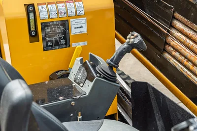 2024 Vermeer D20x22 S3 operator station showing joystick controls, console, safety decals, and loaded drill pipe rack